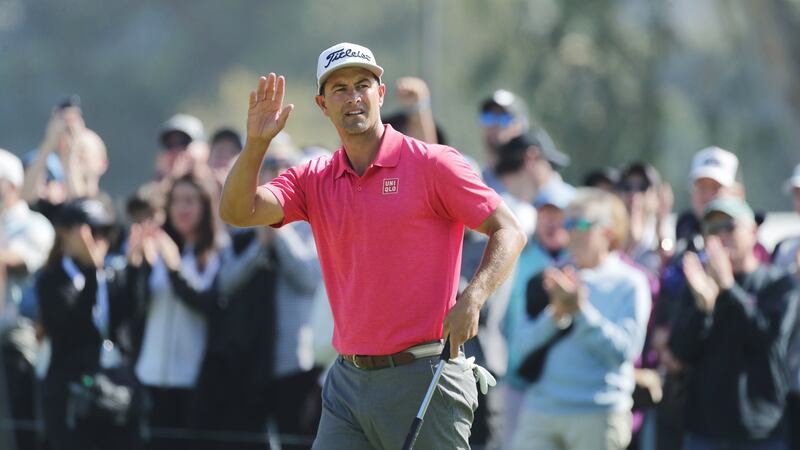 Scott waves to the gallery after making his putt at the third hole. Photo: David Swanson/EPA
