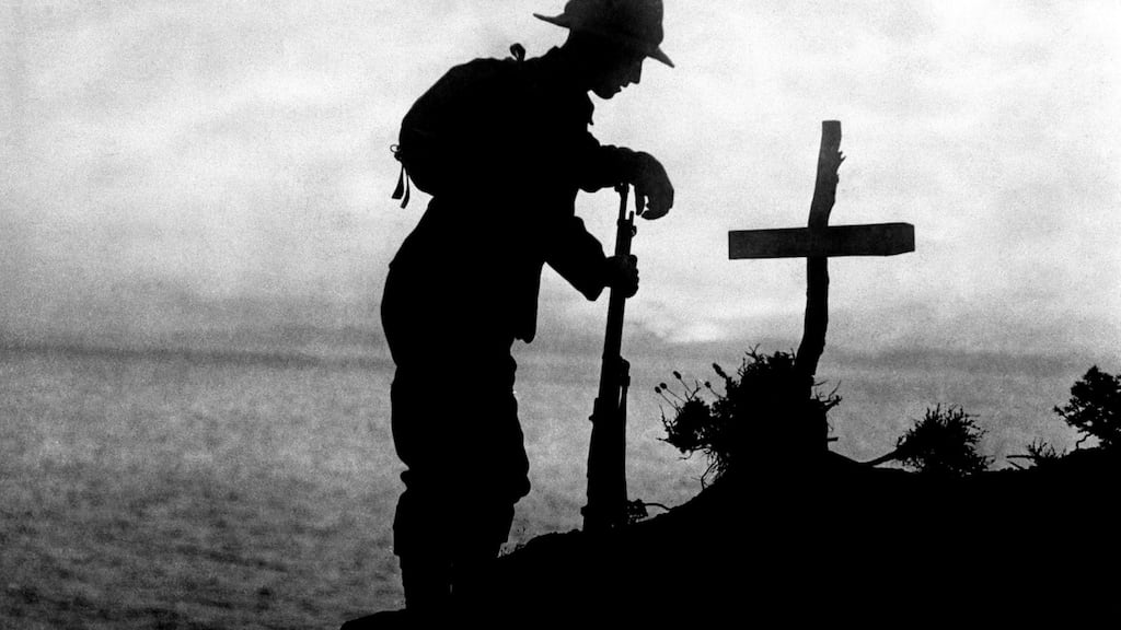 A soldier paying his respects at the grave of a colleague near Cape Helles, Ottoman Empire, where the Gallipoli landings took place in World War One, Dardenelles Front. PA Wire
