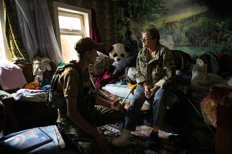 Halyna Bezsmertna (57), is escorted home by Ilya Chernikov, a surgical nurse and volunteer at a mobile clinic in Siversk, in the Donetsk region. Photograph: Lynsey Addario/New York Times