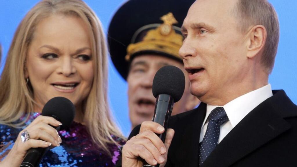 Singer Larisa Dolina and Vladimir Putin sing the Russian national anthem during a concert to mark the Crimea-Russia reunification in Moscow yesterday. Photograph: Maxim Shipenkov/EPA