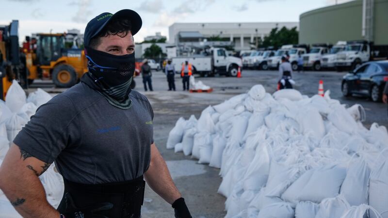 Workers fill sandbags and help load them into residents’ cars in Miami Beach, Florida, on Saturday in preparation for hurricane Dorian. Photograph: Getty images