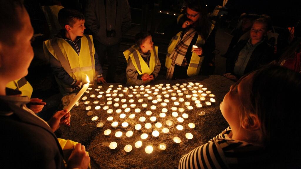 People attend a candlelight vigil for the 10 people who lost their lives Glenamuck halting site fire in Carrickmines,Dublin. Photograph: Stephen Collins/Collins