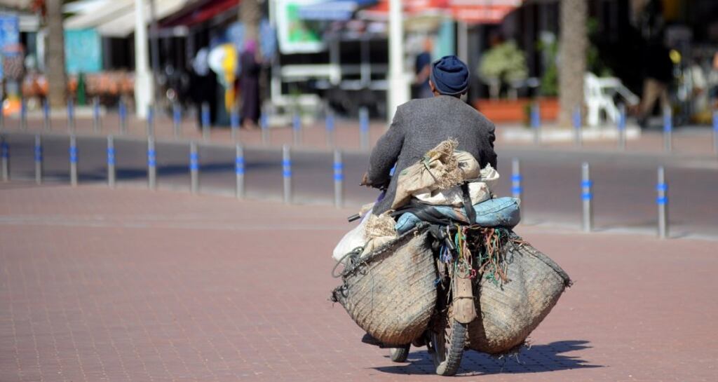 A man transports bags on a moped on the waterfront of Agadir in Morocco. Photograph: Andia/Getty