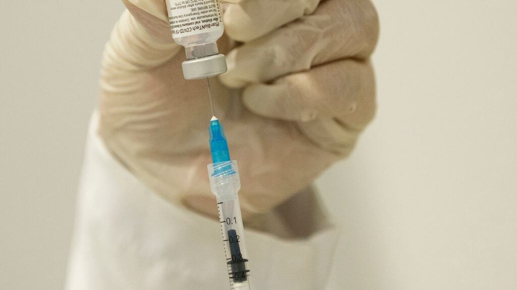 A healthcare worker prepares a dose of the Pfizer/BioNTech Covid-19 vaccine.  Photograph: AFP via Getty Images