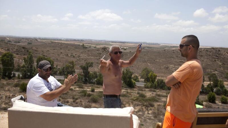 Israelis pictured on a hill overlooking the Gaza Strip near Sderot, Israel. Locals have been gathering on the site to watch Israel’s artillery bombardment of the Gaza Strip. Photograph: Lior Mizrahi/Getty Images