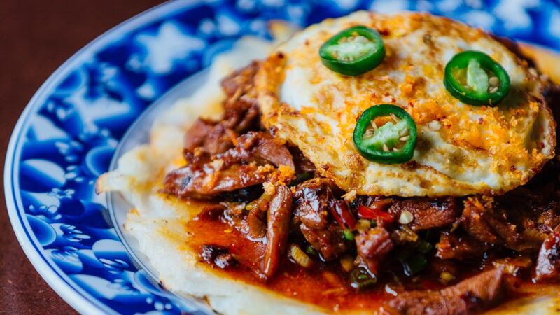 Shredded duck in black bean sauce topped with a fried egg on the brunch menu at Hang Dai