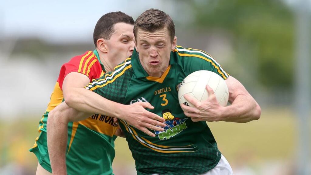 Meath’s Kevin Reilly holds off the challenge from Carlow’s Hugh Gahan during the Leinster quarter-final at Dr Cullen Park. Photograph: Ryan Byrne/Inpho