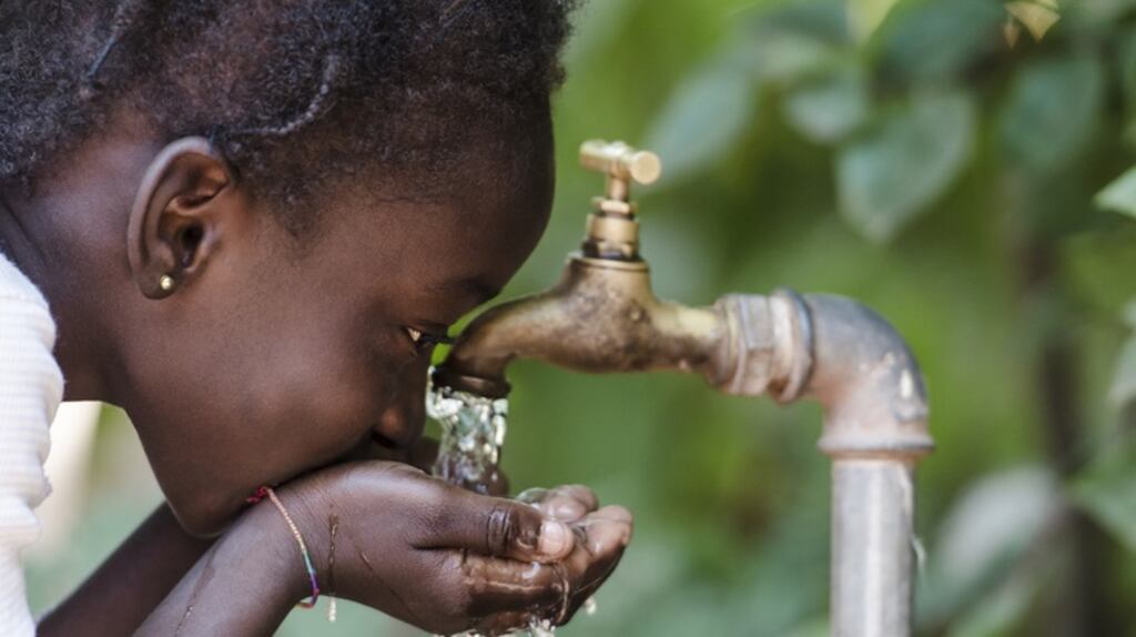 A young girl drinks clean water from a tap in Bamako, Mali. Dóchas says Irish spending on overseas development aid has fallen. Photograph: Getty Images