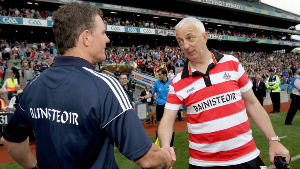 Cork manager Conor Counihan and Galway manager Alan Mulholland shake hands after the game. Photograph: Ryan Byrne/Inpho