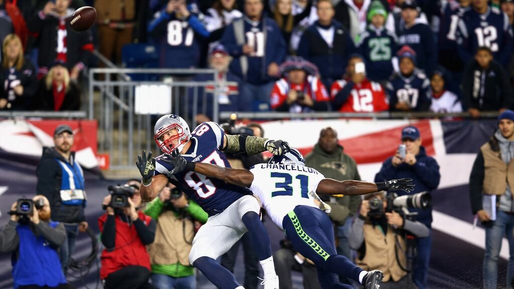 Rob Gronkowski (L) of the New England Patriots attempts to catch a pass as he is tackled by the Seattle Seahawks’ Kam Chancellor. Photograph: Adam Glanzman/Getty