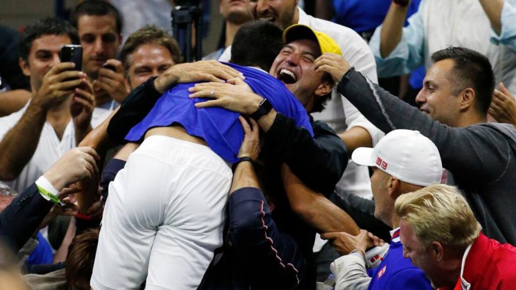 Novak Djokovic, of Serbia, jumps into the arms of supporters after beating Roger Federer in the US Open final. Photograph: Julio Cortez/AP