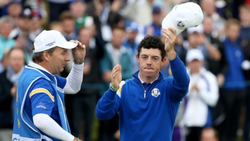 Rory McIlroy of Europe celebrates victory over Rickie Fowler with caddie JP Fitzgerald on the 14th hole  at Gleneagles. Photograph:  Ross Kinnaird/Getty Images