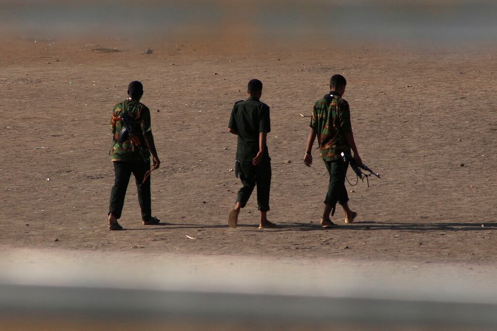Armed men walk in Khartoum on Monday, as fighting between forces loyal to two rival Sudanese  generals continues. Photograph: AFP via Getty Images