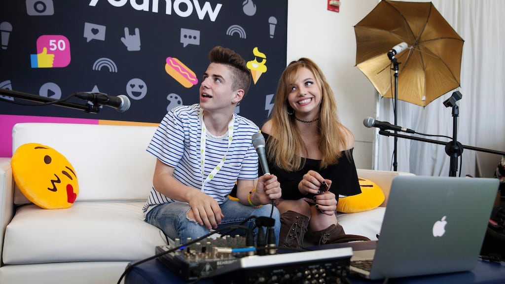 Hailey Knox (17), a singer and YouNow star, broadcasts with Zach Clayton from the YouNow booth at VidCon, a convention for online video, in California. Photograph: Emily Berl/The New York Times