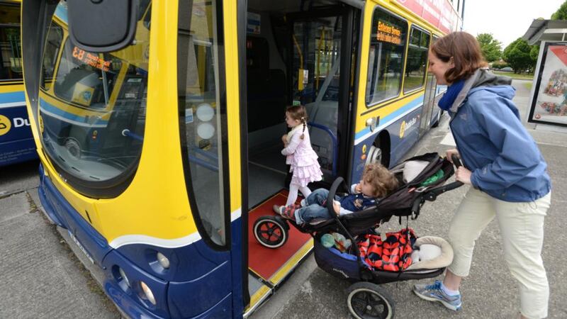 Claire Micks with her children, Lucy (4) and Andy (2), on the 83 bus going into Dublin city. Photograph: Dara Mac Dónaill
