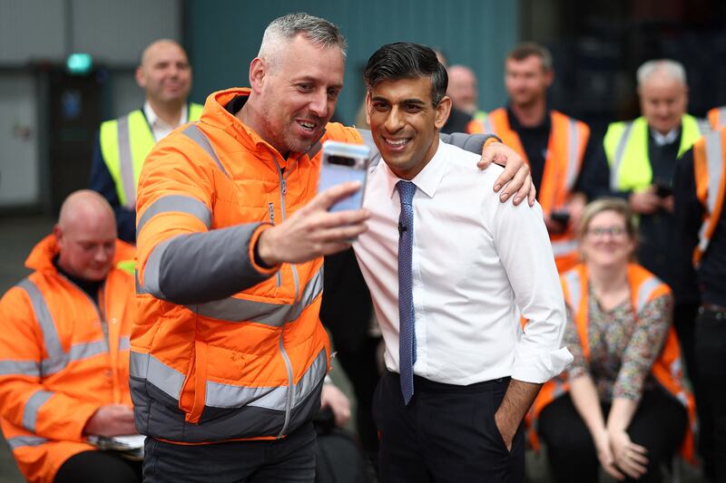 Britain's prime minister Rishi Sunak with staff at a distribution centre in Ilkeston in the East Midlands on Thursday. Photograph: Henry Nicholls/Pool/AFP via Getty Images