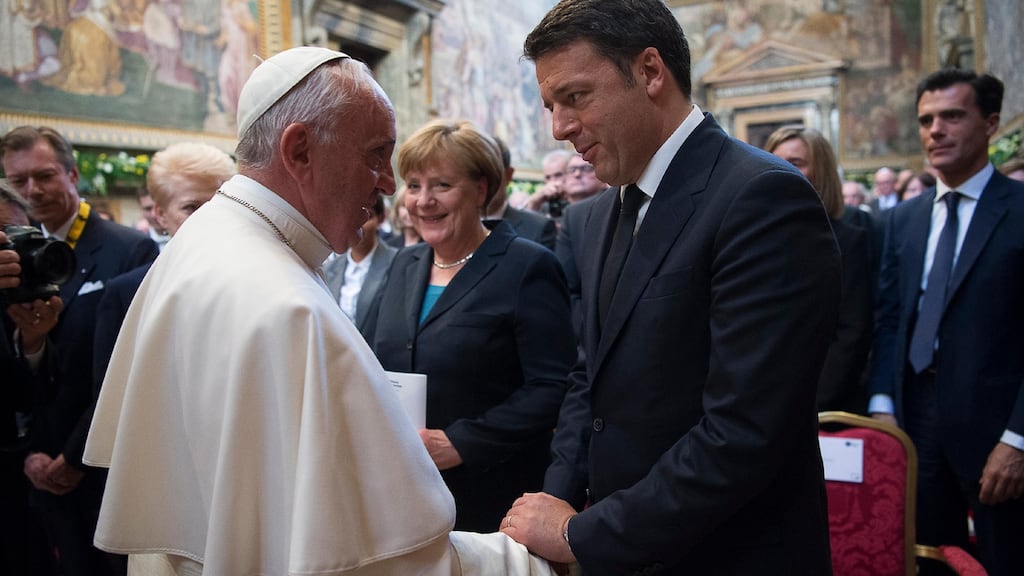 Pope Francis shakes hands with Italian premier Matteo Renzi, as German chancellor Angela Merkel looks on, during a ceremony where he was awarded the International Charlemagne Prize of Aachen (Karlspreis) at the Vatican on Friday. Photograph: L’Osservatore Romano/Pool Photo via AP