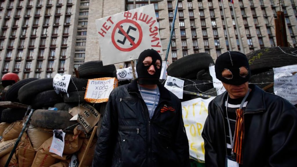 Masked pro-Russia protesters stand guard at a barricade yesterday outside a regional government building in Donetsk, in eastern Ukraine. Photograph: Reuters/Marko Djurica