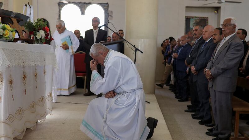 A priest leads the Easter Mass in Mar Gewargis (St George) Chaldean Catholic church, which was damaged by Islamic State militants, in the town of Tel Esqof, Iraq. Photograph: Reuters