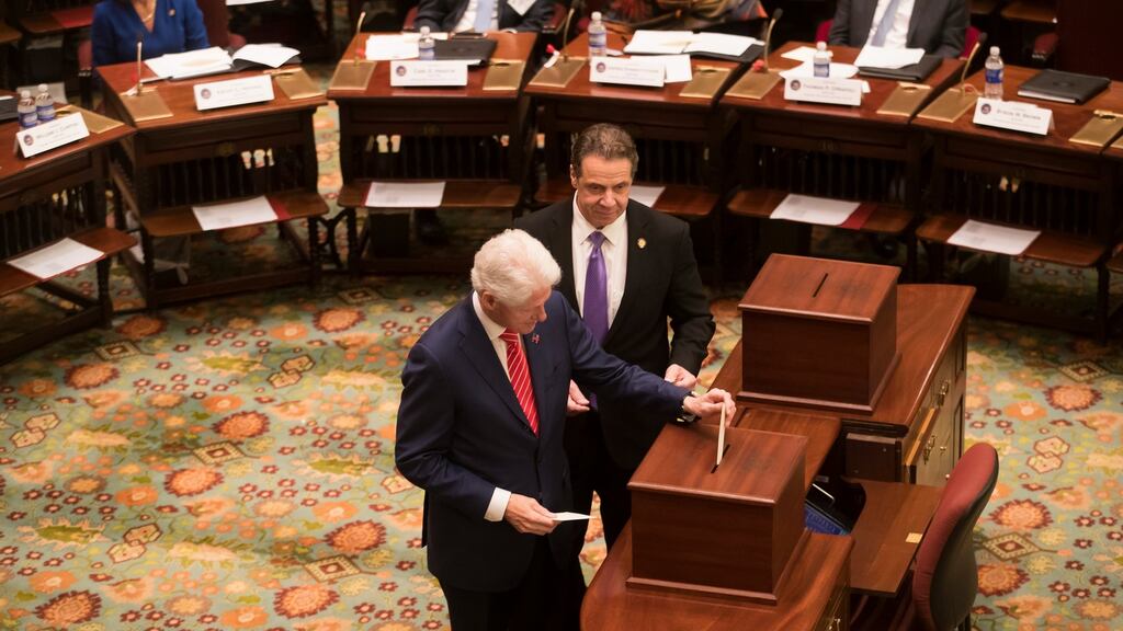 Former US president Bill Clinton and governor Andrew Cuomo cast their votes for Hillary Clinton as electors at the New York State Senate in Albany on Monday. Photograph: Nathaniel Brooks/New York Times