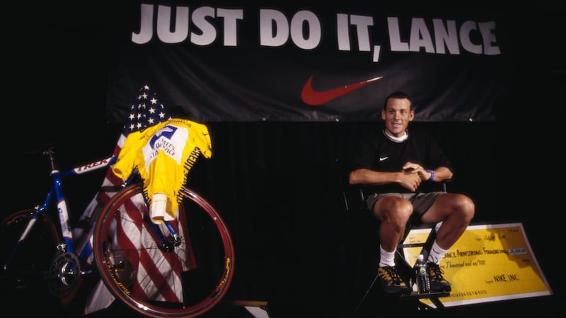 Armstrong receives a $25,000 donation for the Lance Armstrong Foundation in 1999. Photo: James Leynse/Corbis via Getty Images
