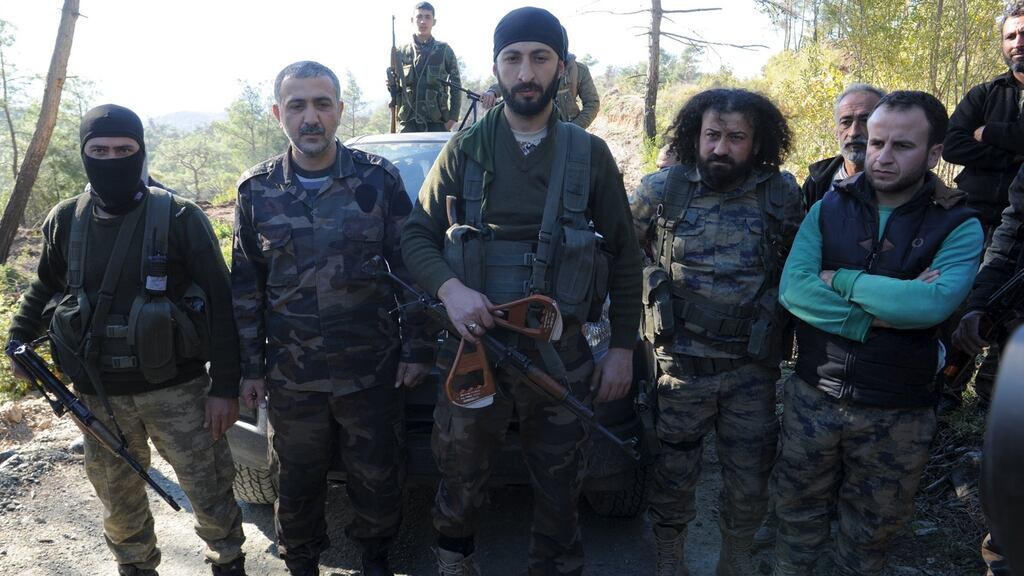 A deputy commander in a Syrian Turkmen brigade holds handles from a parachute of the downed Russian warplane near the northern Syrian village of Yamadi: Turkey has reportedly apologised to Russia over the incident which occurred last November. Photograph: Reuters/Stringer