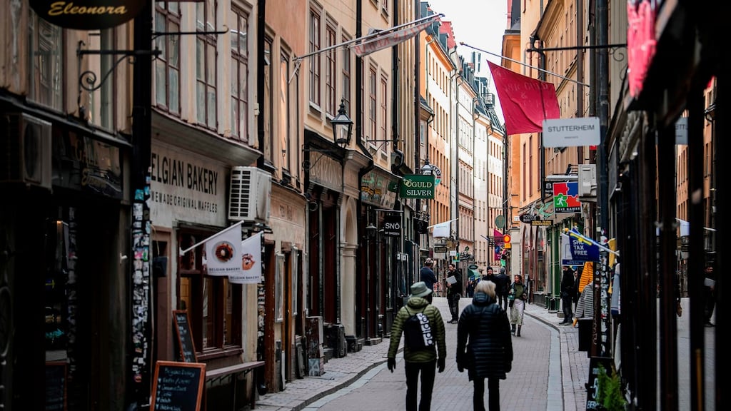 People walk in the main street of the old town in Stockholm, Sweden.  While the rest of Europe is in near-lockdown in a bid to curb the spread of the  Covid-19,  Sweden is taking a softer line. Photograph: AFP via Getty
