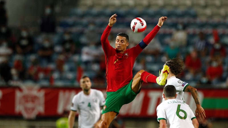 Cristiano Ronaldo jumps ahead of Josh Cullen and Jeff Hendrick during Portugall’s later win over Ireland. Photograph: Antonio Cotrim/EPA