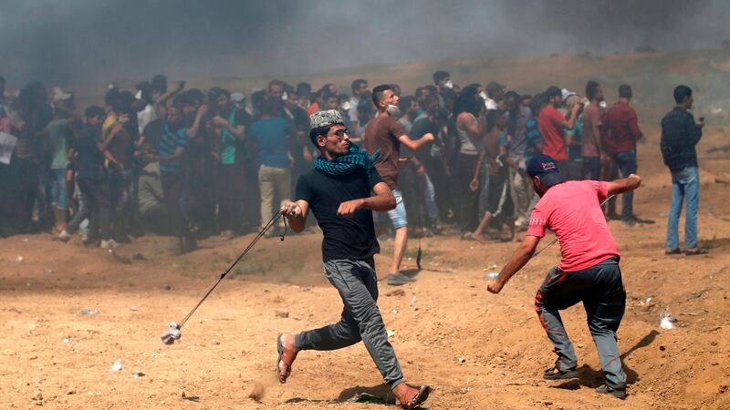 Palestinian protesters use slingshot to throw rocks at Israeli forces. Photograph: Mohammed Abed/AFP/Getty Images