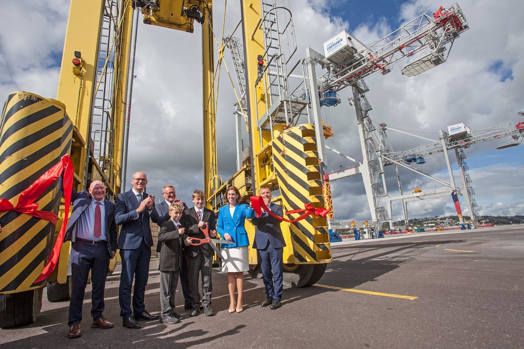 At the feet of giants: Crosshaven Boys NS pupils Peter McCann and Thomas Buckley, with (from left) Michael Walsh, chairman of Port of Cork Company; Simon Coveney, Minister for Foreign Affairs; Eoin McGettigan, CEO, Port of Cork Company; Hildegarde Naughton, Minister of State; and Michael McGrath, Minister for Public Expenditure, at the launch of Cork Container Terminal. Photograph: Diane Cusack