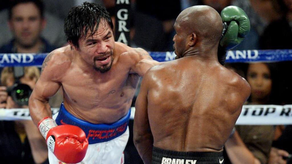 Manny Pacquiao (red gloves) lands a left on Timothy Bradley during their WBO world welterweight title bout at MGM Grand Garden Arena. Photograph: Joe Camporeale/USA TODAY Sports