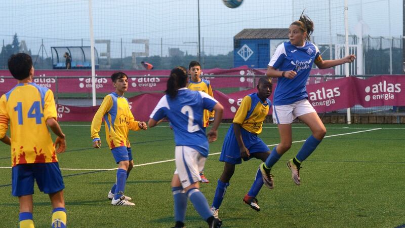 Andrea Gómez, the striker for AEM Lleida, heads a ball against a boys team in Lleida, Spain, April 25, 2017. Photograph: Samuel Aranda/The New York Times