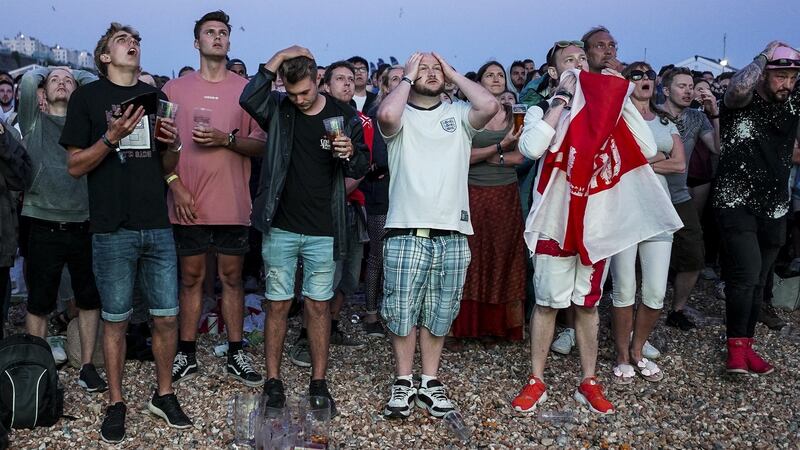England fans react to Croatia’s winning goal on Brighton Beach. Photo: Alan Crowhurst/Getty Images