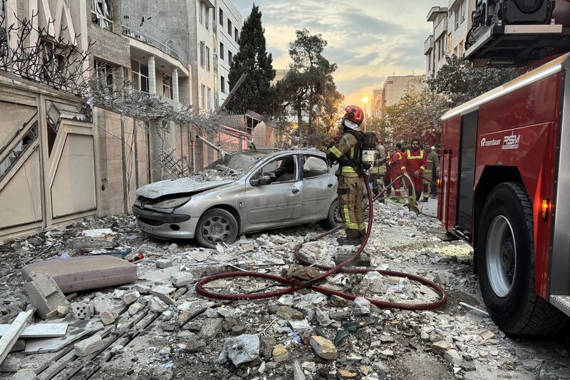 First responders gather outside a building that was hit by an Israeli strike in Tehran. Photograph: Meghdad Madadi/Tasnim News/AFP via Getty Images