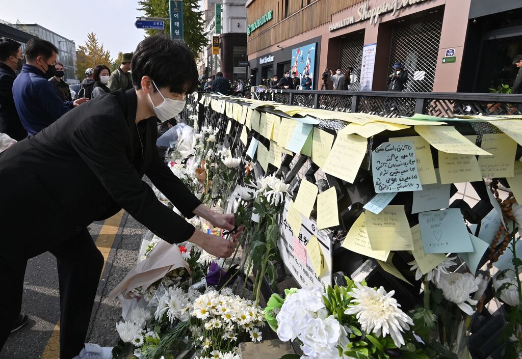 A mourner lays flowers at a makeshift memorial for the victims of the deadly Halloween crowd surge, outside a subway station in the district of Itaewon in Seoul on November 1st, 2022. Photograph: JUNG YEON-JE/AFP via Getty Images