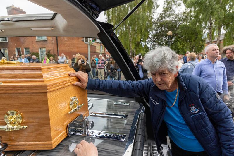 A mourner reaches to touch Br Crowley's coffin on Saturday. Photograph: Tom Honan