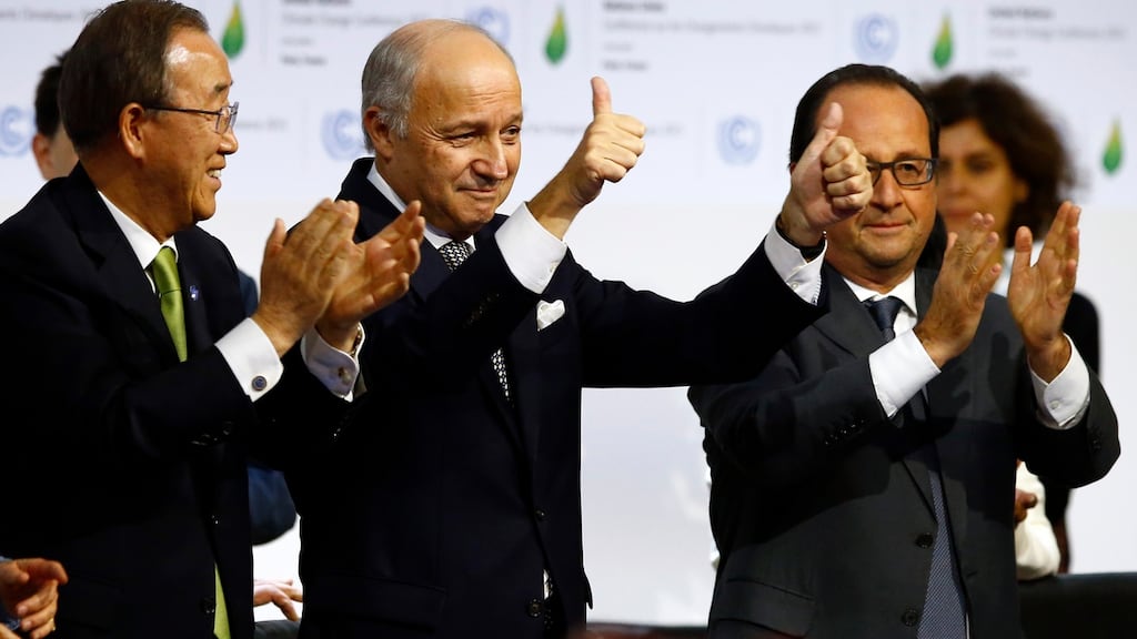 UN secretary general Ban Ki-moon, COP21 president Laurent Fabius and François Hollande after the climate change accord was adopted in Paris. Photograph: François Mori/AP Photo
