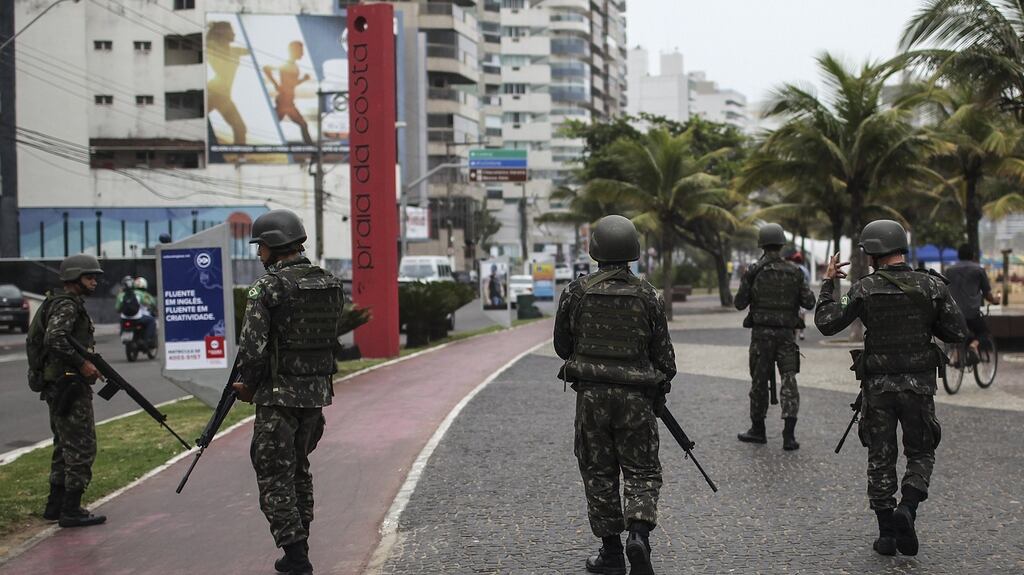 Soldiers patrol the streets of Vitória, Espírito Santo, Brazil on Thursday: residents locked themselves in their homes as violence swept through the city after police went on strike. Photograph: Antonio Lacerda/EPA