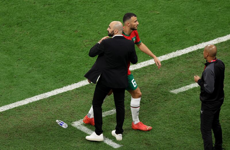 Morocc's Romain Saiss is consoled by coach Walid Regragui as he leaves the field after 20 minutes due to injury. Photograph: Clive Brunskill/Getty Images