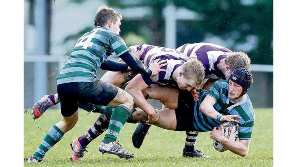 Clongowes Sebastien Fromm and William Lappin tackle St Gerard's Con Callan as Sam Kingston tries to offer support during yesterday's Leinster Schools Senior Cup first-round match at St Marys RFC, Dublin. photograph: Inpho
