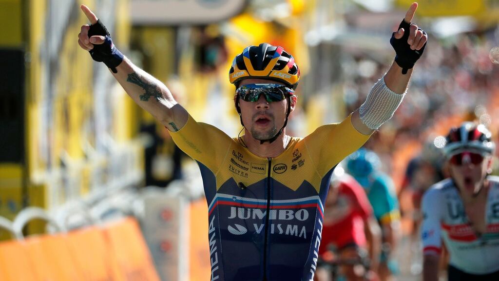 Primoz Roglic celebrates as he crosses the finish line to win the fourth stage of the Tour de France between Sisteron and Orcieres-Merlette. Photograph: Stephane Mahe/AFP via Getty Images