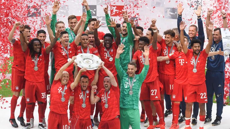 Arjen Robben, Rafinha and Franck Ribery lift the trophy in Munich. Photograph: Getty Images