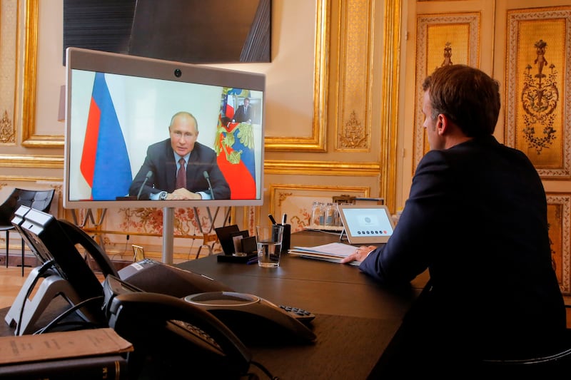Emmanuel Macron talks to Vladimir Putin during a video conference in June 2020. Photograph: Michel Euler/Pool/AFP via Getty Images