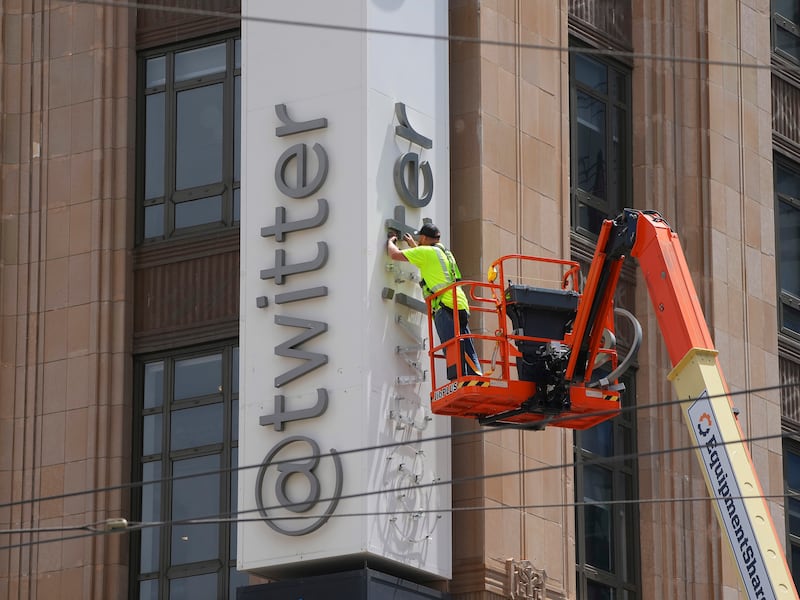 Workers remove letters from the Twitter sign at the company's headquarters in San Francisco before the San Francisco Police Department stopped them for performing 'unauthorised work'. Photograph: Jim Wilson/New York Times