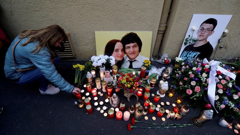 A woman kneels by a memorial on the first anniversary of the murder of the investigative reporter Jan Kuciak and his fiancee Martina Kusnirova in Bratislava, Slovakia. Photograph: David W Cerny/Reuters