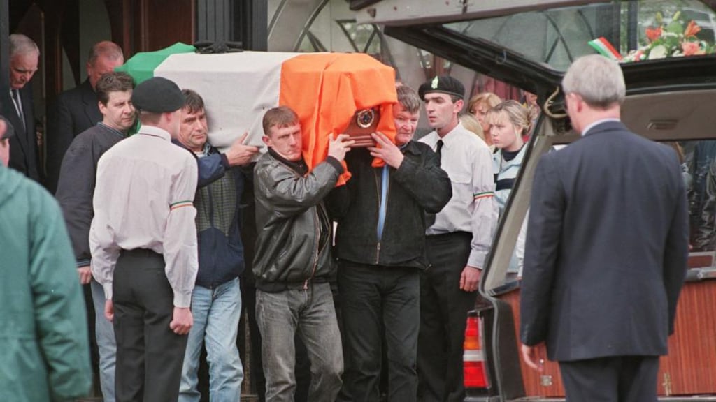 A colour party forms a guard of honour as the coffin bearing the remains of Real IRA member Ronán MacLochlainn leaves Massey Brothers Funeral Home in Finglas Village in 1998. Photograph: Matt Kavanagh The coffin bearing the remains of dissident IRA man Ronan MacLochlainn leaves the funeral home in 1998. Photograph: Matt Kavanagh