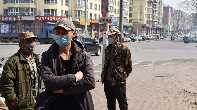 Daily wage workers in Suifenhe on the Russia border. Photograph: Huizhong Wu/Reuters