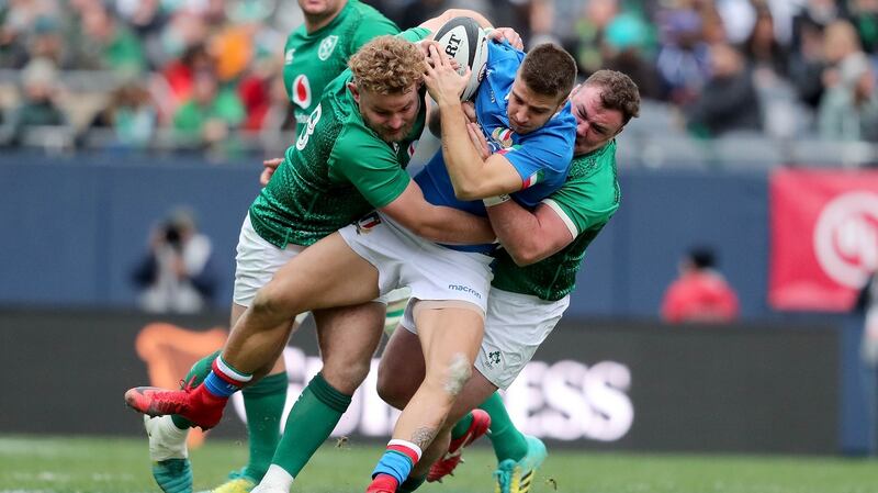 Italy’s Luca Sperandio is tackled by Finlay Bealham and Dave Kilcoyne of Ireland during the match at Soldier Field in Chicago. Photograph: Dan Sheridan/Inpho