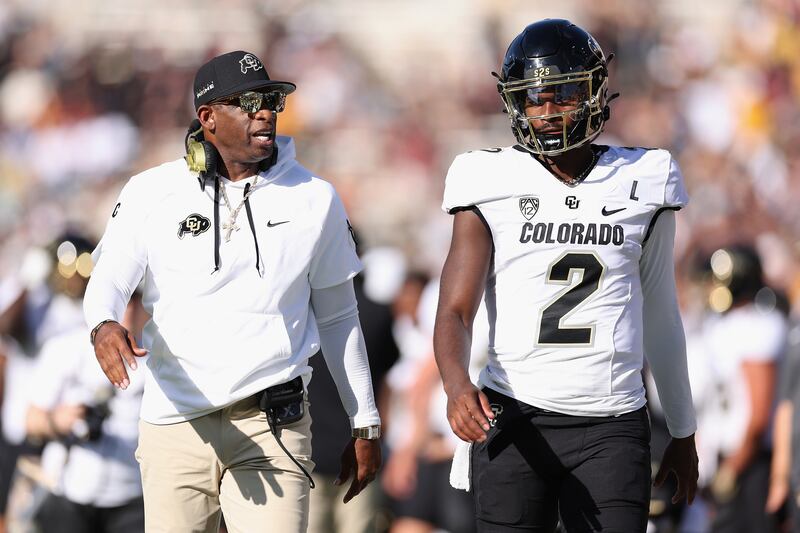 Deion Sanders, head coach of the Colorado Buffaloes, talks to his quarterback son Shedeur Sanders in a 2023 game against the Arizona State Sun Devils in Tempe, Arizona. Photograph: Christian Petersen/Getty