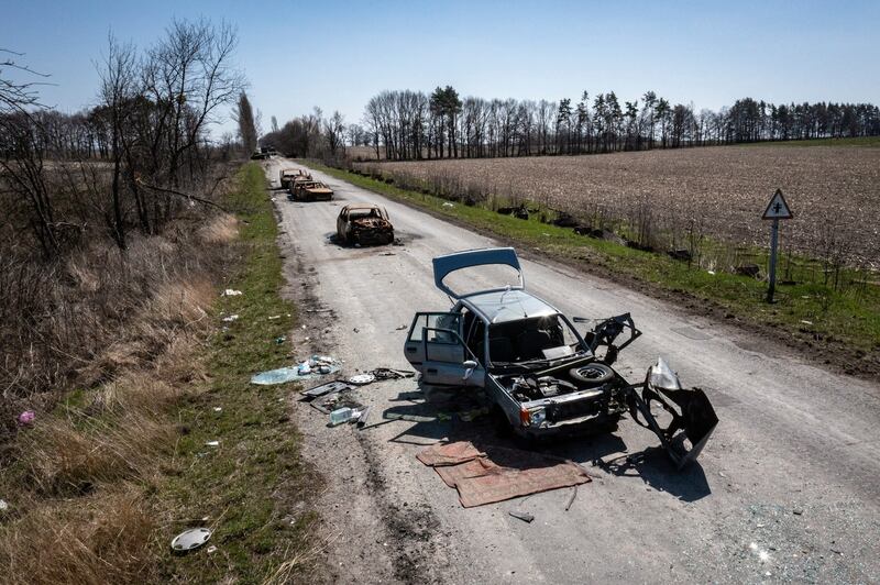 The charred wreckage of a civilian convoy remains on a road leading out of the village of Lypivka, Ukraine. Photograph: David Guttenfelder/The New York Times